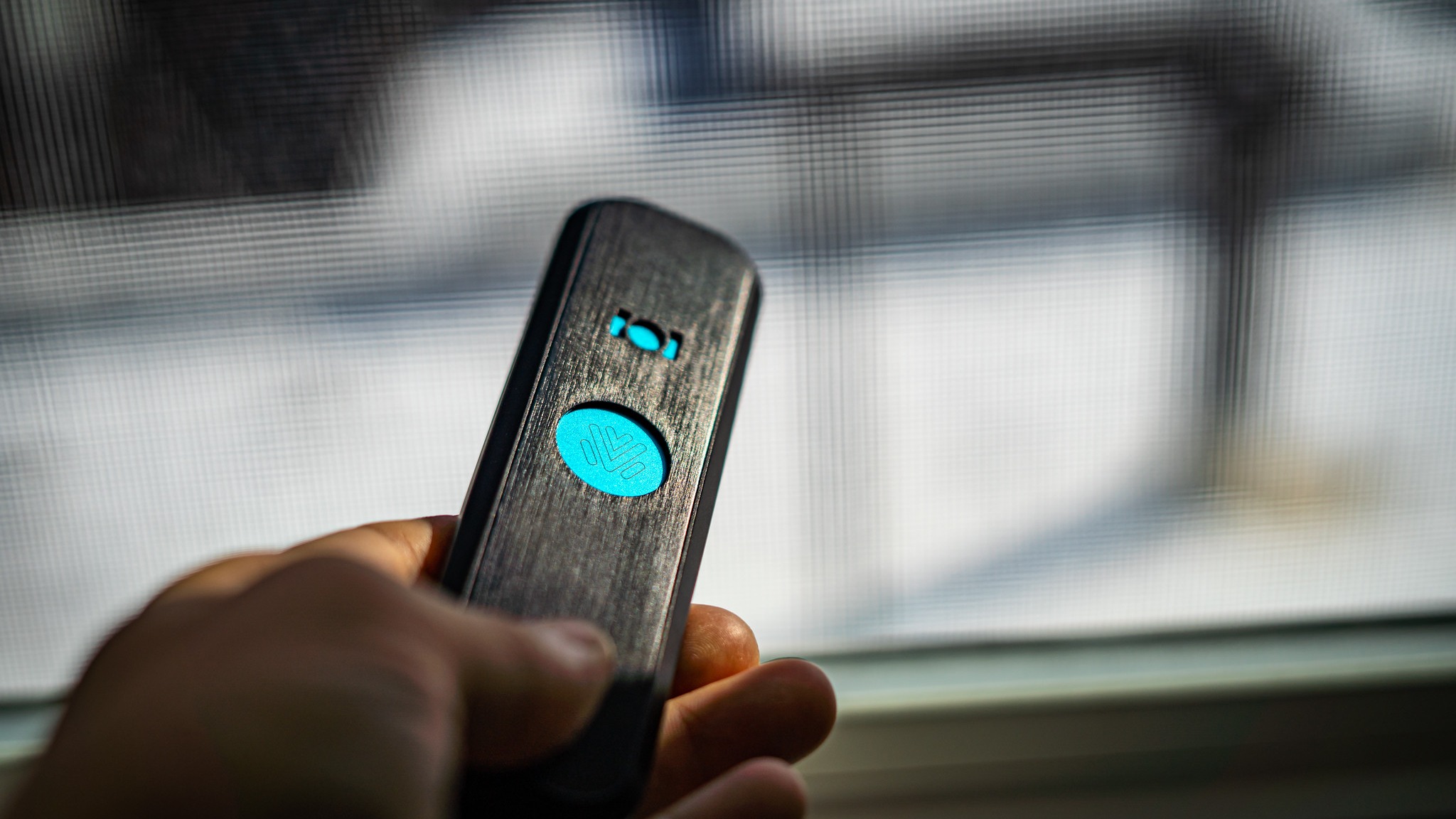 OASIS pipe held in hand, teal LED glowing